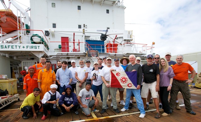 The expedition team & Mermaid crew underway, displaying the Explorer’s Club flag