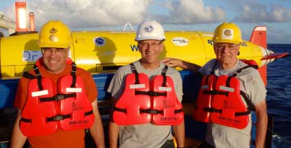 Bryan McCoy, Tom Vinson, and Rod Blocksome pose with the REMUS AUV